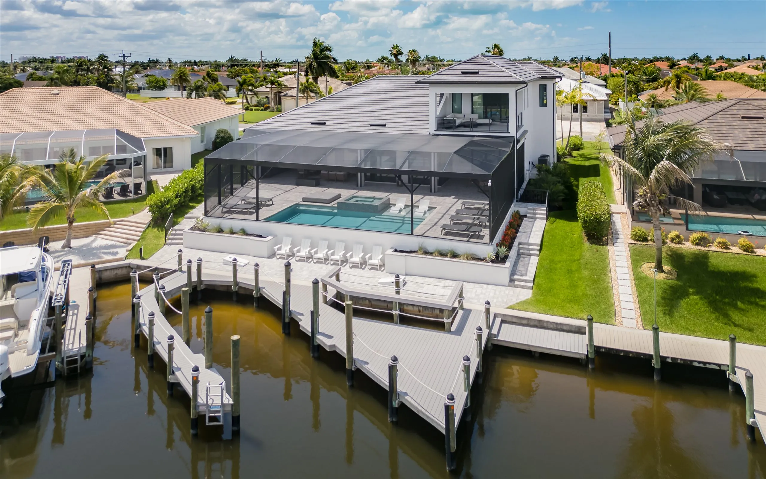 Aerial view of Villa Sauvage with its pool, private dock, and Gulf-access canal in Cape Coral
