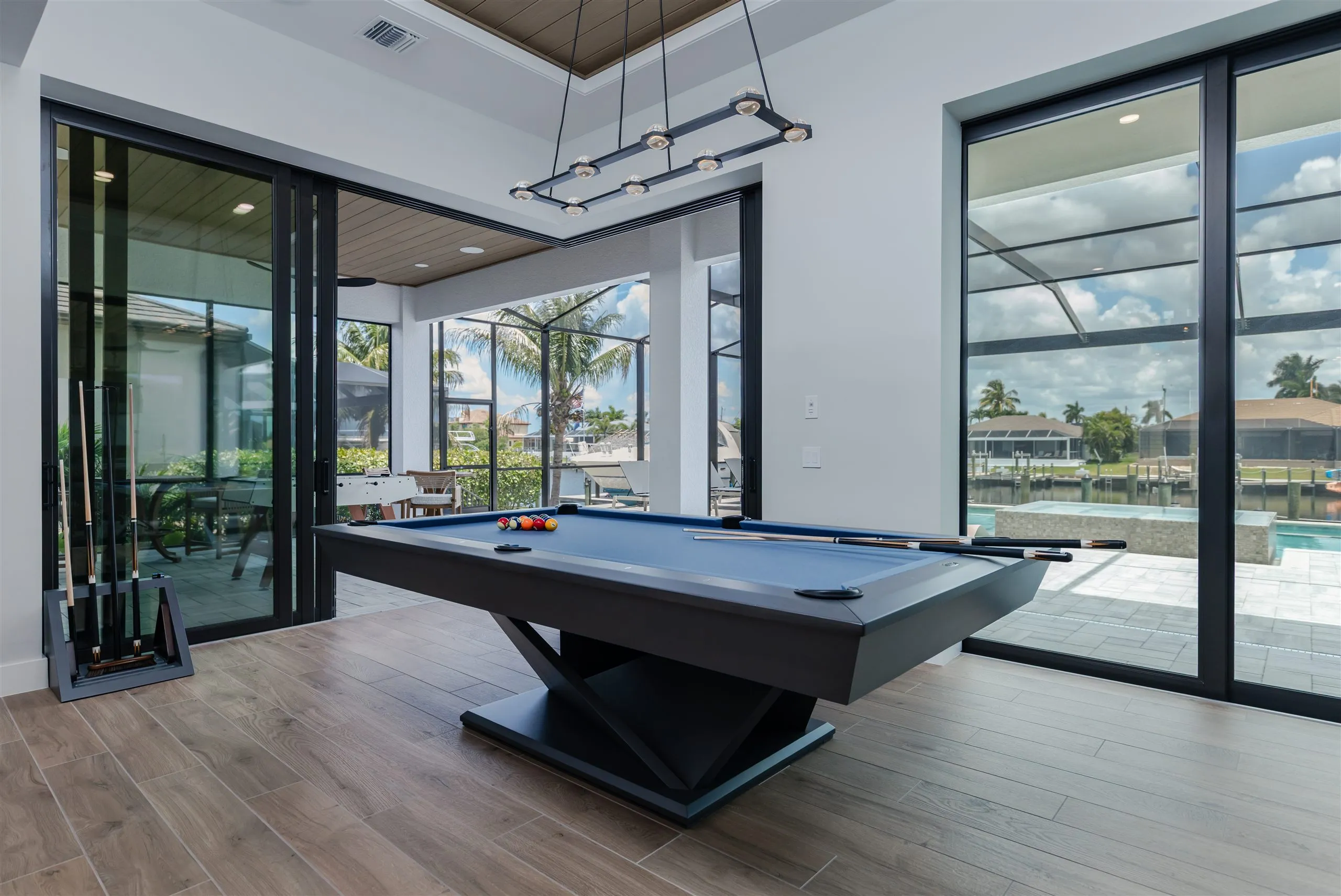 The game room with pool table open to the lanai